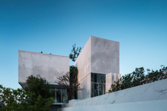 all white home with perforated cladding