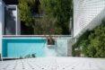 aerial shot of all white home with blue swimming pool