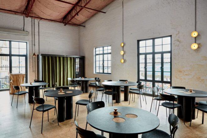 dining area in a restaurant, featuring round tables and chairs
