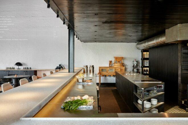 a look into the bar, with steel counters and food prep materials set out
