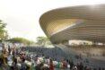 rendering of curving wood building with an outdoor ampitheater