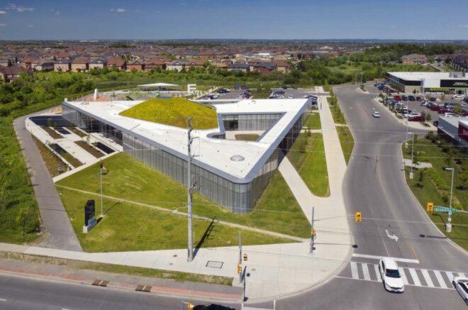 aerial view of triangle-shaped building with hilly green roof