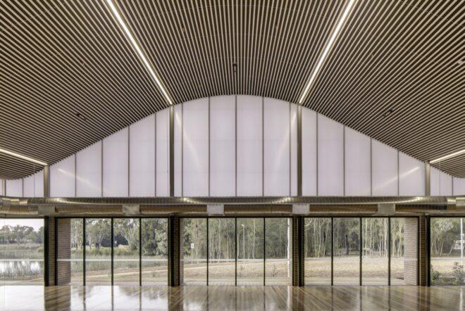 large open room with wavy ceiling and glass walls