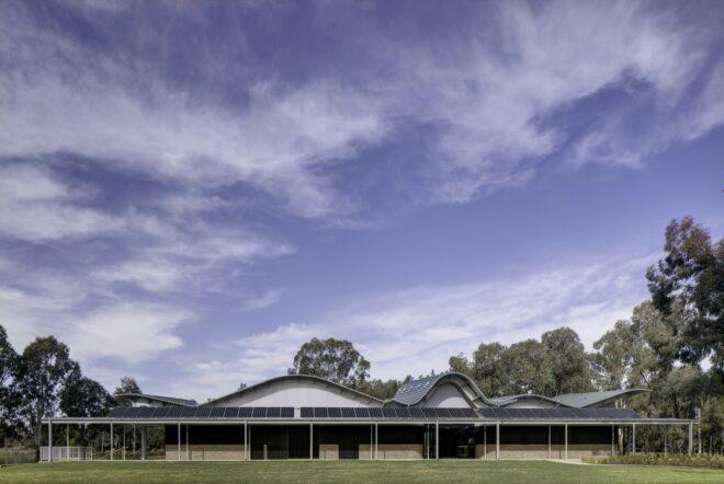 elongated one-story building with a wavy roof