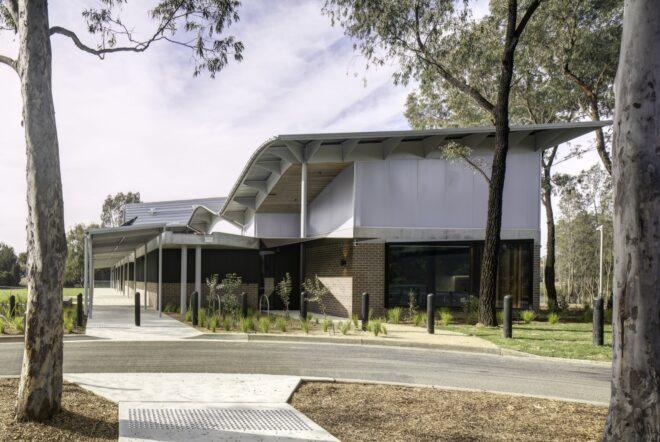 walkways leading to building with wavy roof