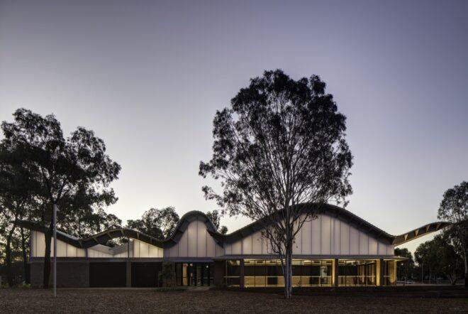 glass building with wavy roof