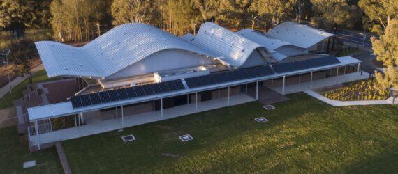 elongated one-story building with a wavy roof
