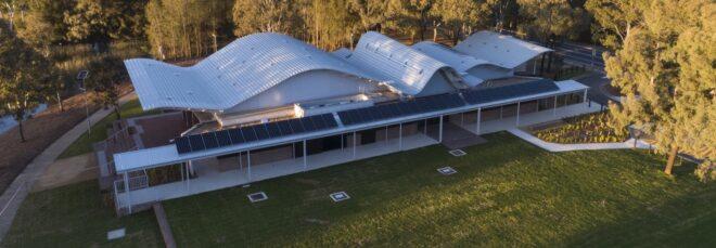 elongated one-story building with a wavy roof