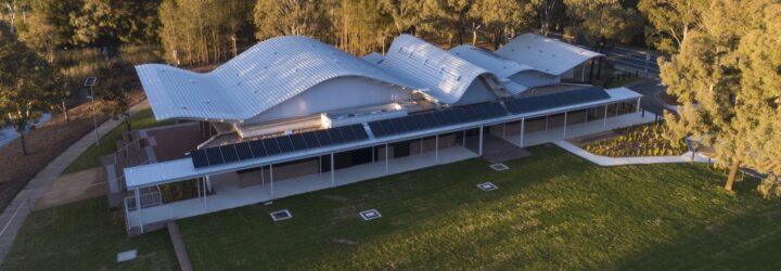 elongated one-story building with a wavy roof