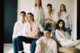 several models in white button-down shirts and jeans