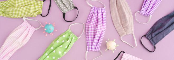 various patterned cloth masks on light purple background