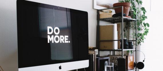large desktop computer with background that reads, 