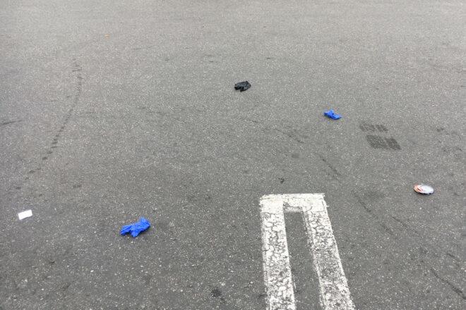 blue and black latex gloves littered in a parking lot