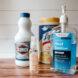 bleach, disinfecting wipes and hand sanitizer on wood table