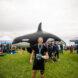 person standing in front of inflated orca