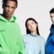 three people layered in bright T-shirts, sweatshirts and sweatpants