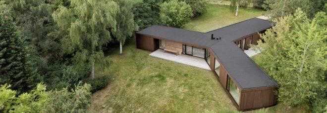 wood and weathered steel home with three connected long volumes