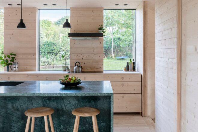 light wood-lined kitchen with a dark gray island