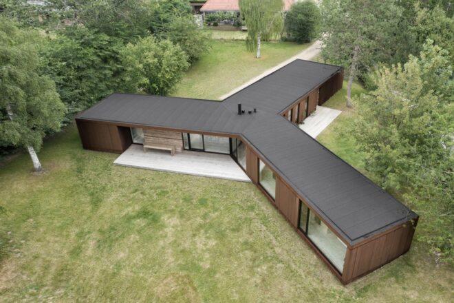 wood and weathered steel home with three connected long volumes