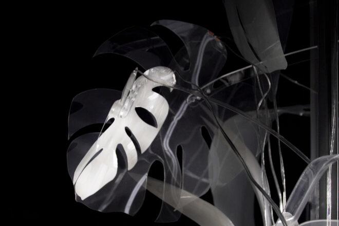 a closeup of a lit-up leaf form surrounded by non-lit leaves on the art piece