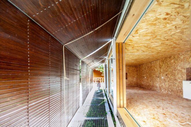 an exterior walkway with roll up shutters
