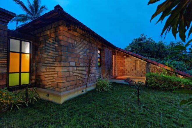 brick and terracotta cottage at night