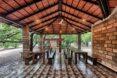 wood tables and benches in a covered pavilion