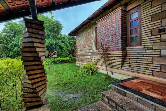 grassy yard beside a brick building with spiral brick columns