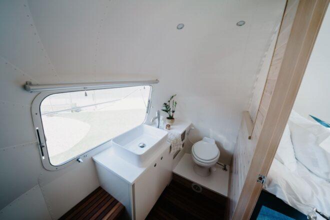 bathroom with white sink area and a small window