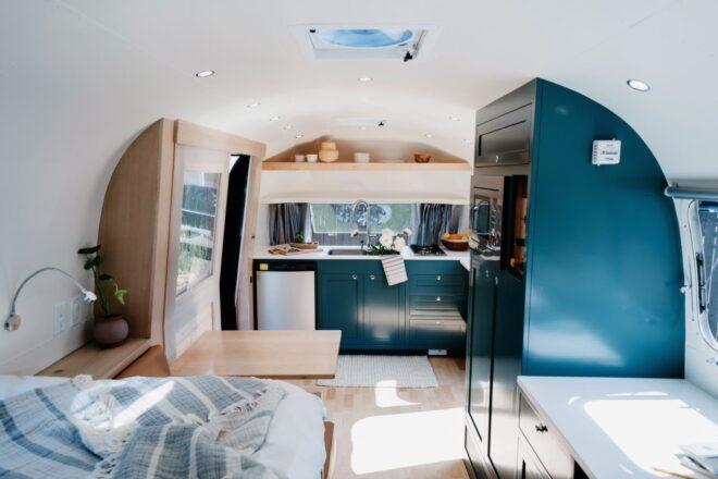 dark green kitchen cabinets inside an Airstream