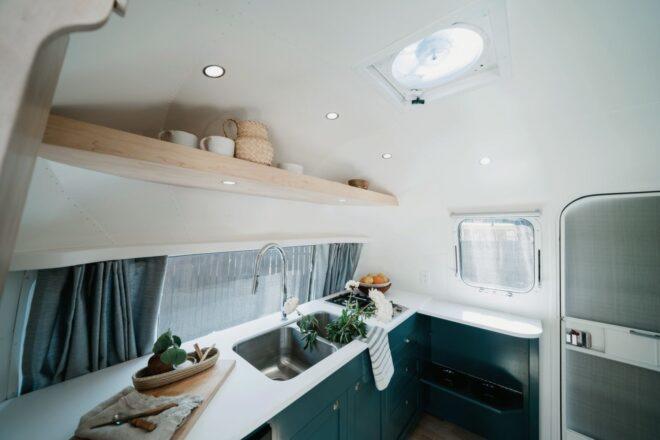 compact kitchen with white countertop and open shelves