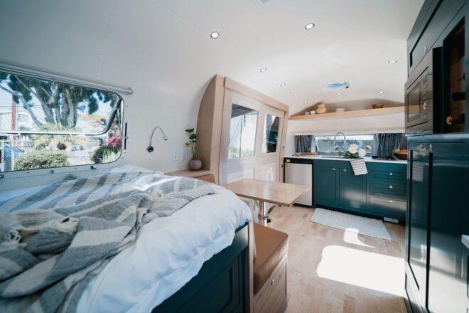 white bed with a dinette set at the foot of the bed