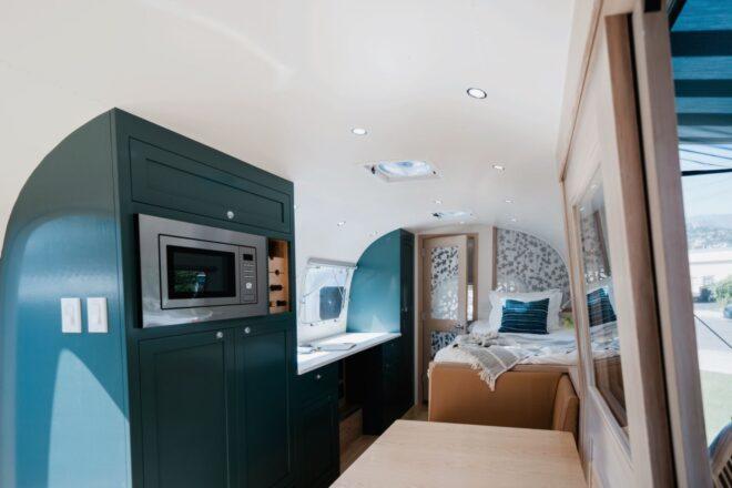 microwave built into dark green cabinet