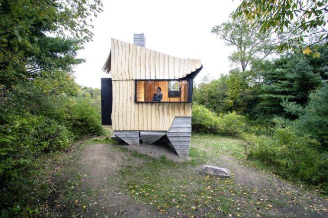 angular cabin set on elevated concrete base