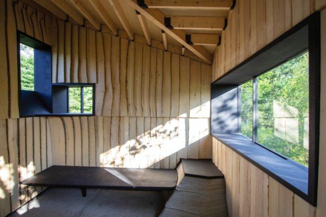 small wood cabin interior with benches along the walls
