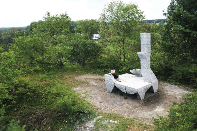 concrete base set on elevated stilts with large chimney