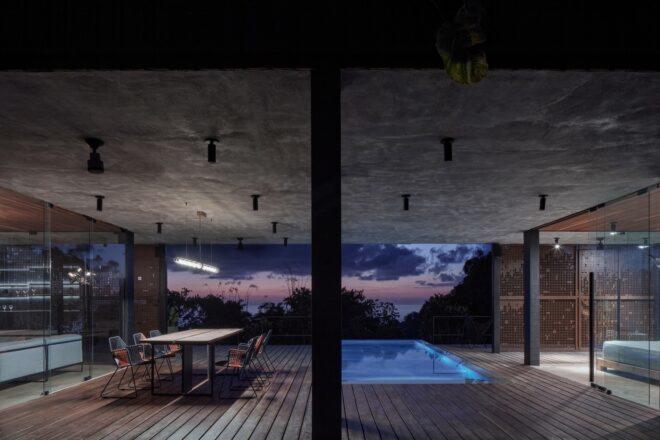 covered outdoor space with pool and dining table