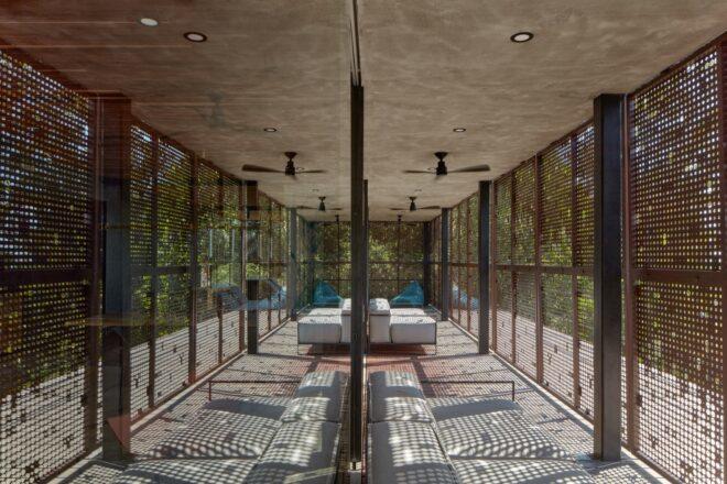 large white sofas in a room with glass walls