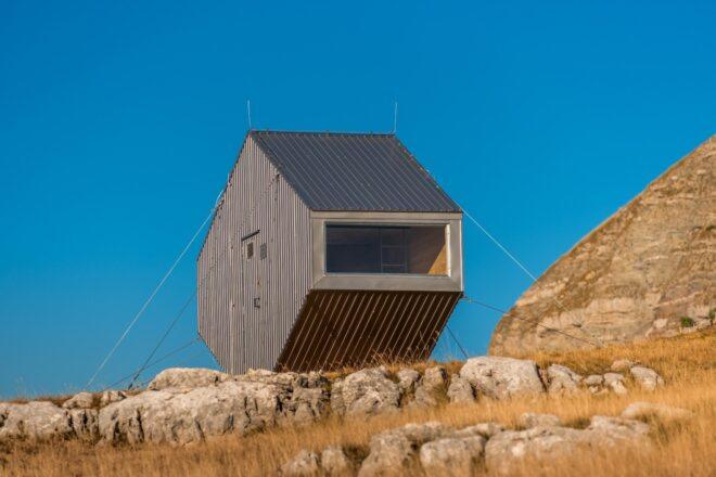 bivouac clad in dark grey panels