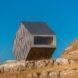 bivouac clad in dark grey panels