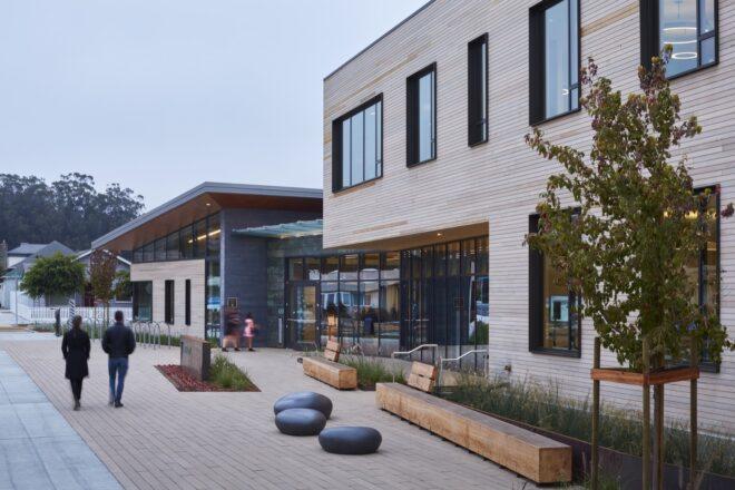 wood benches and round seats outside a wood building