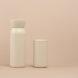 white water bottle and white reusable coffee cup on pink background