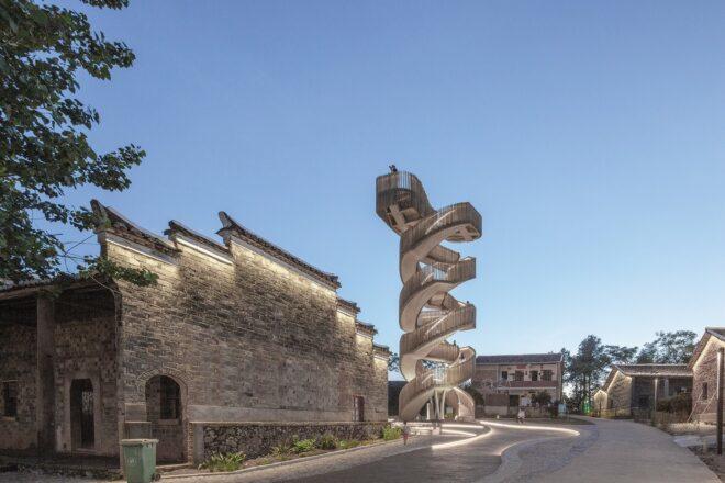 rendering of spiraling wood watchtower beside ancient stone building