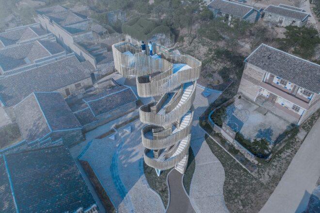 aerial rendering of spiral wooden watchtower in a village