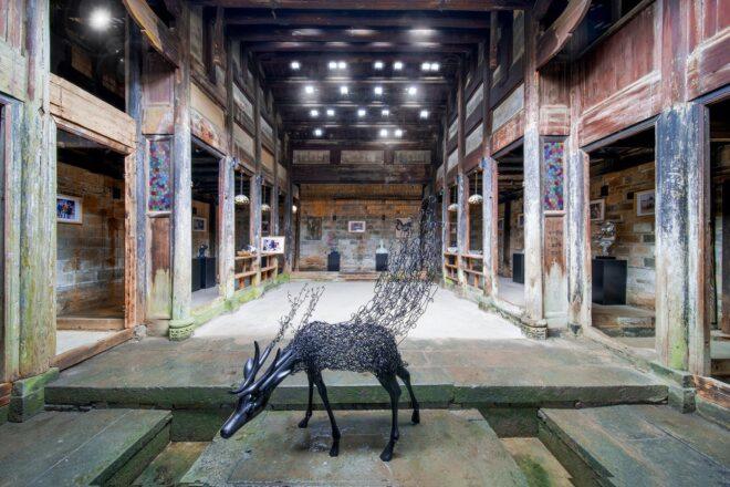 rendering of sculpture of an animal inside an old stone building