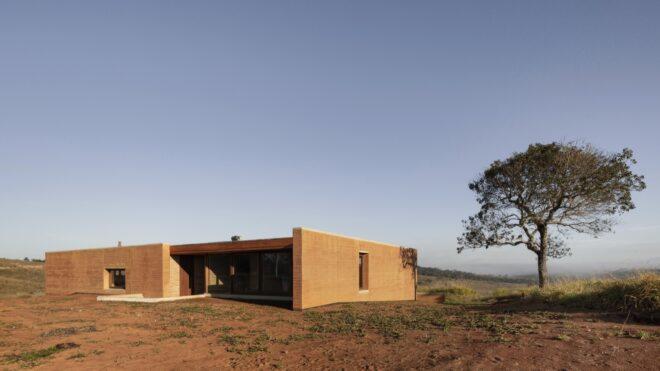 home with tall, rammed earth walls