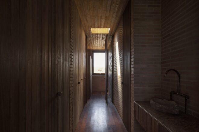long dark hallway with a window on one end