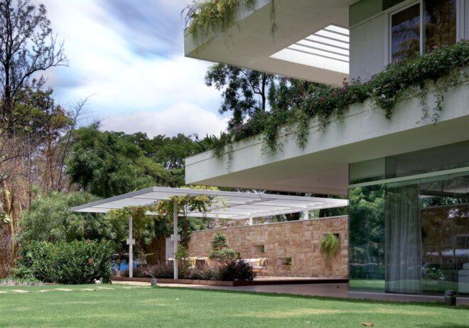 stone home with balconies covered in greenery