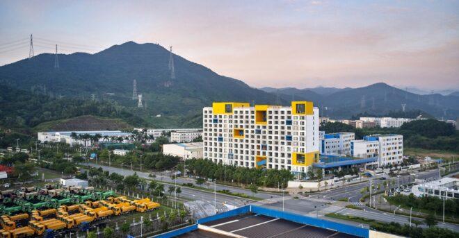 a shot of the Jinlong School from a block away, showing a mountain in the background
