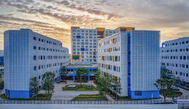 a school campus comprised of three main buildings with blue and yellow accents